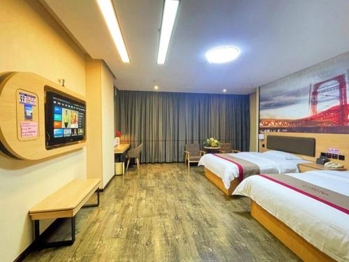 a hotel room with two beds and a flat screen tv at Thank Inn Plus Hotel Guangdong Yunfu Luoding City Municipal in Yunfu