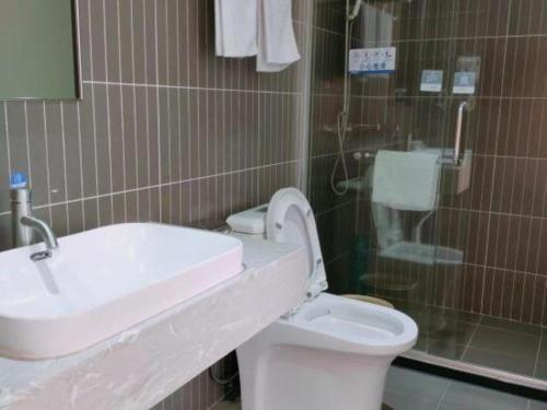 a bathroom with a sink and a toilet at Thank Inn Plus Hotel Guangdong Yunfu Luoding City Municipal in Yunfu