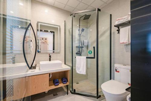 a bathroom with a shower and a sink and a toilet at Shell Hotel Bozhou Lixin County Passenger Center in Lixin