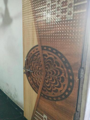 a wooden door with a swirl design on it at Mathura vrindavan Gokul Dham in Mathura