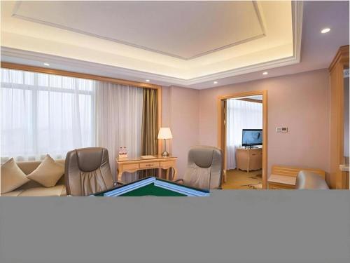 a living room with a couch and a pool table at Vienna Hotel Guangxi Fangcheng in Fangcheng
