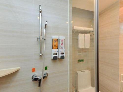 a bathroom with a shower and a toilet at Vienna Hotel Guangdong Foshan Shunde Longjiang Material City in Shunde