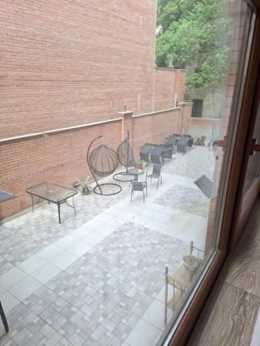 a view of a patio with chairs and tables at Aura Plaza Hotel in Tbilisi City