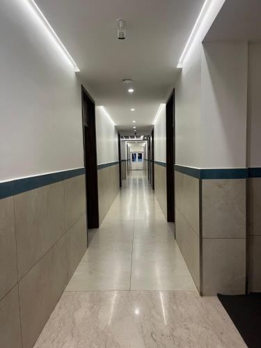 a hallway of a building with a long corridor at Rathna Residency in Tiruppattūr