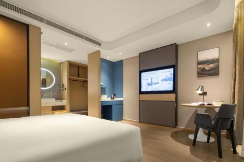 a hotel room with a bed and a television at Atour Hotel Taiyuan Inner Ring in Taiyuan