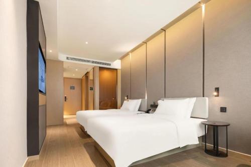 a large white bed in a hotel room at Atour Hotel Taiyuan Inner Ring in Taiyuan