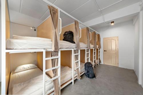 a room with a bunch of bunk beds at Kuha Phuket Old Town in Phuket Town