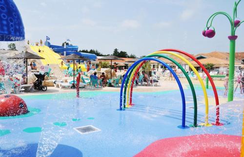 a water park with a pool with a water slide at Mobilhome 602 in Les Mathes