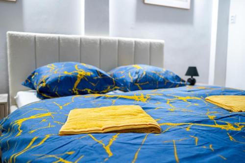 a bed with blue sheets and blue pillows at Cozy Main Square Apartment III with Breakfast in Košice