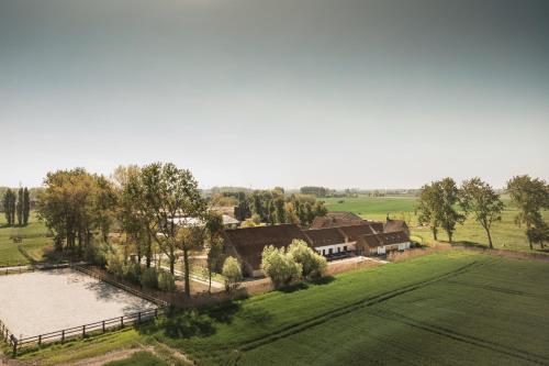 an aerial view of a house in a field at Hoeve De Hemel in Zuienkerke