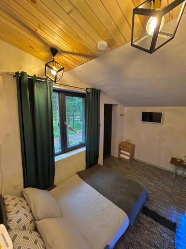 a bedroom with a large bed with green curtains at Quattro Malyovitsa- Мальовица in Govedartsi
