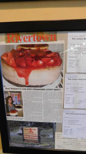 a poster of a cake with strawberries on it at West Gate Inn Nyack in Nyack