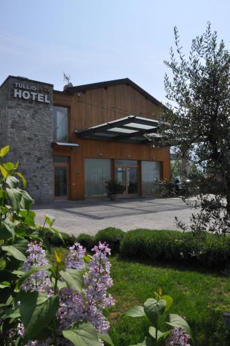 a building with a sign that reads hotel at Tullio Hotel in Gravedona