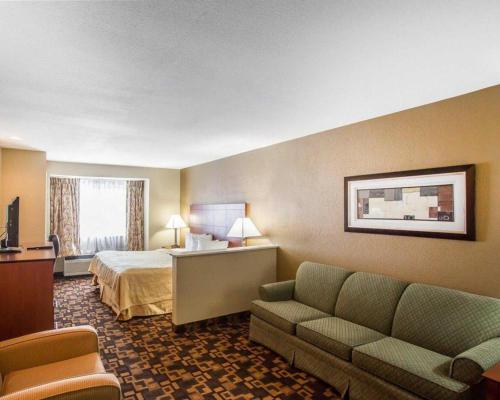 a hotel room with a bed and a couch at Quality Inn & Suites in Mount Juliet