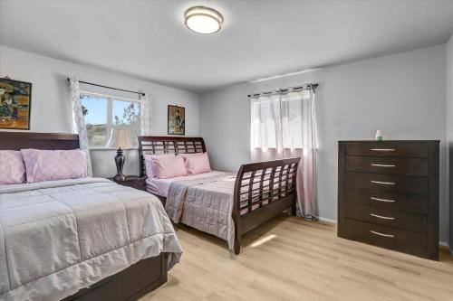 a bedroom with two beds and a dresser at 16 Plus ADU Solana Beach DelMar Fair in Encinitas