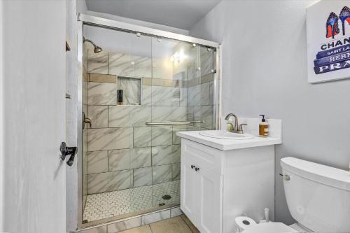 a bathroom with a shower with a sink and a toilet at 16 Plus ADU Solana Beach DelMar Fair in Encinitas