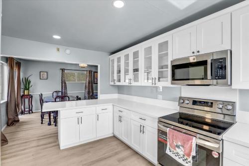 a kitchen with white cabinets and a stove top oven at 16 Plus ADU Solana Beach DelMar Fair in Encinitas