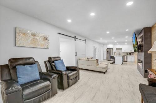 a living room with two chairs and a tv at 16 Plus ADU Solana Beach DelMar Fair in Encinitas