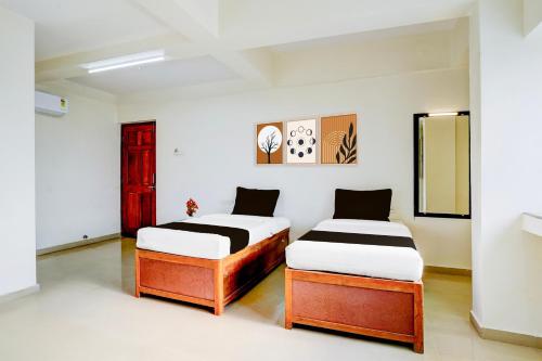 Ένα ή περισσότερα κρεβάτια σε δωμάτιο στο Hotel O Pachgaon Near Kolhapur Film Institute