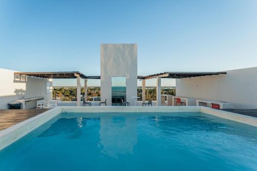 a swimming pool on the roof of a building at Penthouse en Chicxulub in Chicxulub
