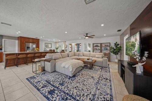 a large living room with a couch and a kitchen at Temporary Sanity in Sarasota