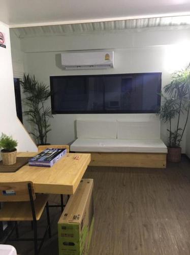 a living room with a large flat screen tv on the wall at Khao Yai the kids adventure in Mu Si