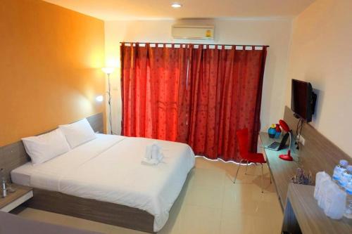 a bedroom with a bed and a red curtain at The Pride in Nakhon Pathom