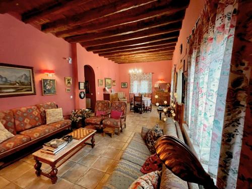 a large living room with couches and a table at Casa rural de la Abuela in Cadreita