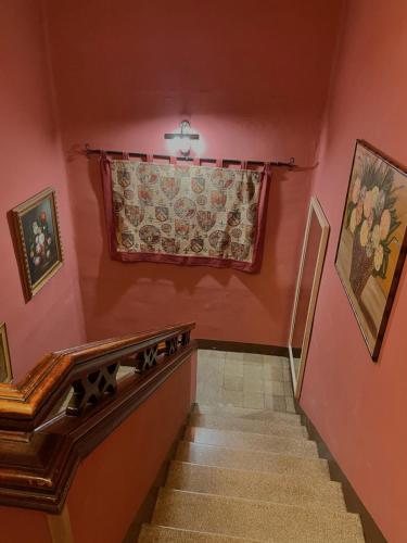 a staircase in a home with pink walls and a window at Casa rural de la Abuela in Cadreita
