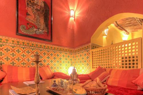 a living room with a couch and a table at Les Matins Bleus in Essaouira