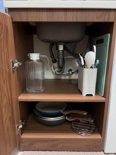 a kitchen cabinet with a mixer and utensils at The Purrfect Stay in Lapu Lapu City