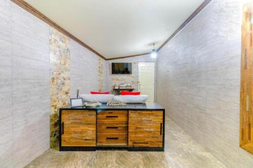 a room with a wooden cabinet and a wall at OYO 750 Baan Suan Ampond in Bangkok