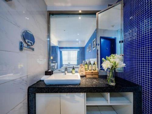 a bathroom with a sink and a mirror at Xian Hotel New in Xi'an