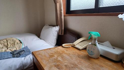 Postel nebo postele na pokoji v ubytování 和風ホテル福島屋