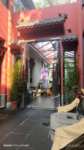 a red building with a dog sitting in front of it at YOYO PINKE Hotel in Beijing