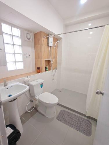 a bathroom with a toilet and a sink and a shower at 57 Hidden House BKK Chinatown in Bangkok