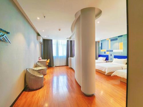 a hotel room with a bed and a bed and a room at 7 Days Inn Yining Xintiandi in Kipekyüzi