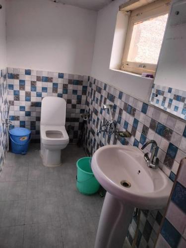 a bathroom with a white sink and a toilet at RI-YOUL HOUSE Pangong in Lukung