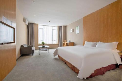 a large white bed in a hotel room at The Art Hotel in Shenzhen