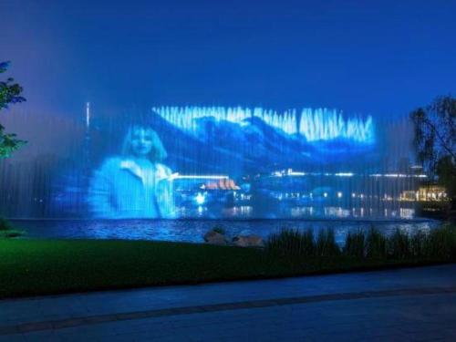 a large screen with a picture of a city at night at Linyi Blue Horizon International Hotel Yi He in Linyi