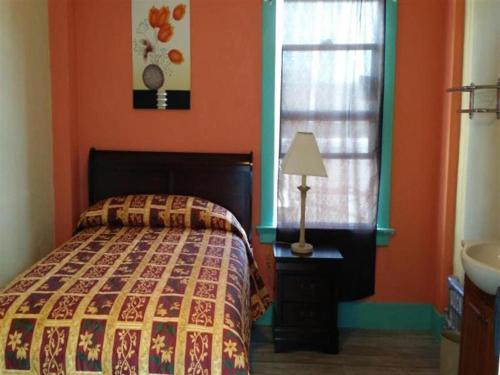 a bedroom with a bed and a window and a sink at Desmond Hotel in San Francisco