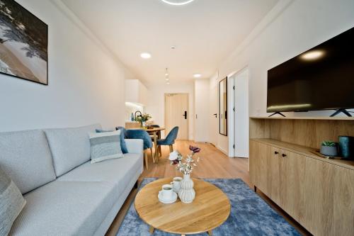 a living room with a couch and a table at Aparthotel Anchoria BlueApart in Mechelinki