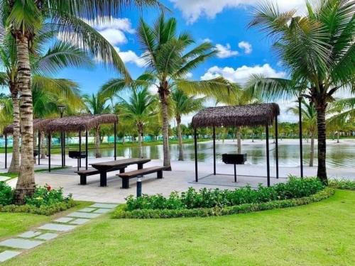a park with picnic tables and palm trees at Shi House -Studios BS7 Cozy Vinhomes Grand Park in Ho Chi Minh City