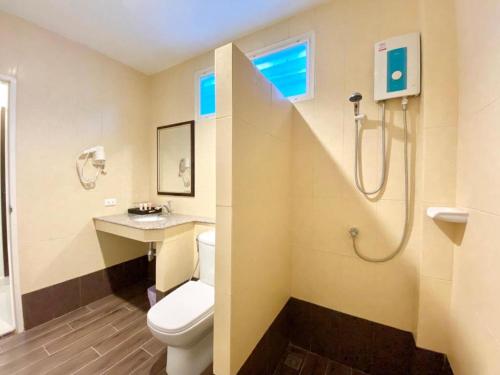 a bathroom with a toilet and a sink and a shower at Ruen Maihom Riverside Cottage in Ban Tha Nam Tun