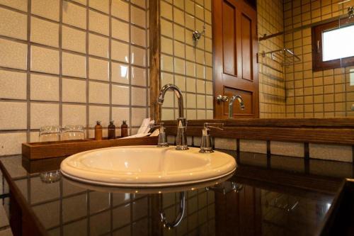 a bathroom with a sink and a mirror at Ruean Racha in Chiang Mai