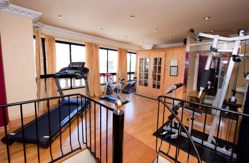 a gym with treadmills and a fitness room with treadleys at Hotel Juanito in La Roda