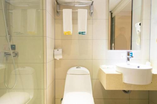 a bathroom with a toilet and a sink and a shower at City Comfort Inn Wuhan High Speed Railway Station in Wuhan