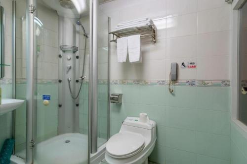 a bathroom with a shower and a toilet and a sink at Golden Lustre Hotel in Shenzhen