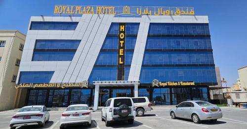 a building with cars parked in front of it at Royal Plaza Hotel in Duqm