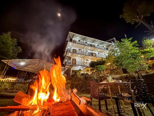 a fire pit in front of a building at night at Winterline Gold Resort in Lansdowne